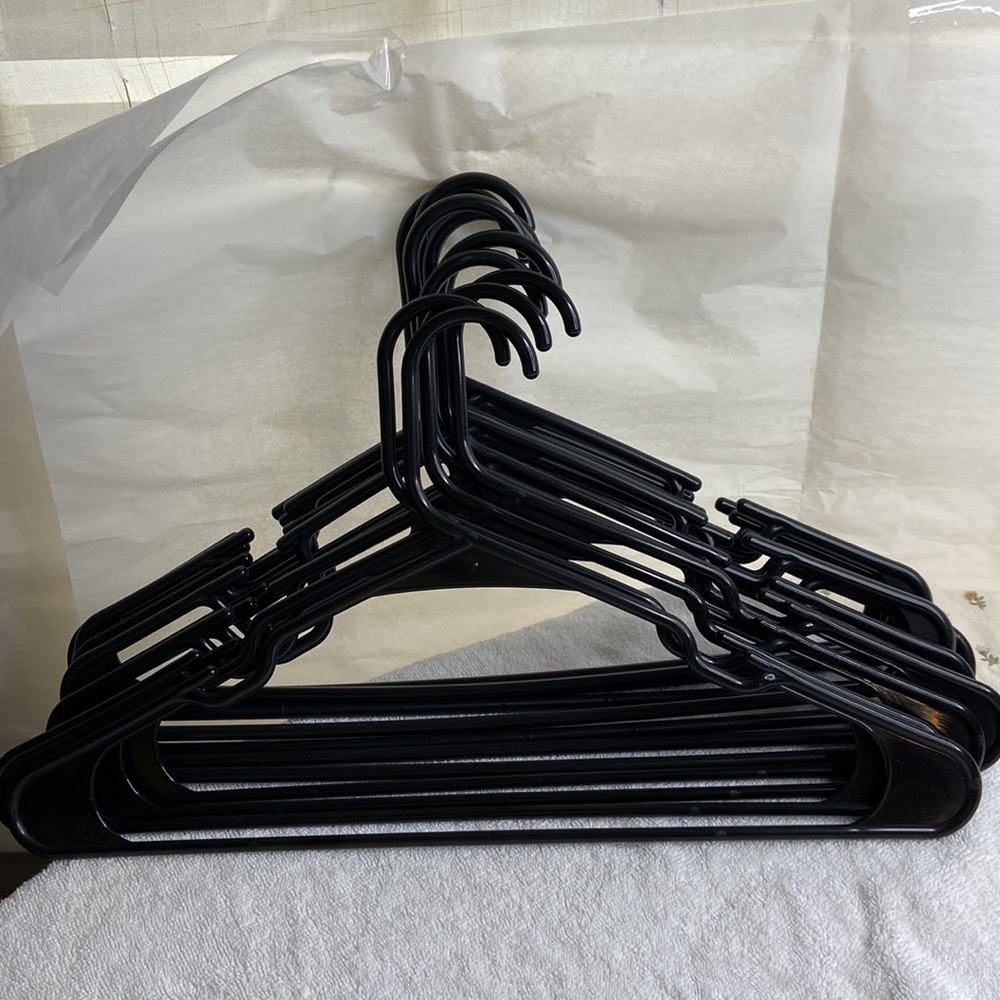 12 each plastic black used hangers with shoulder grooves